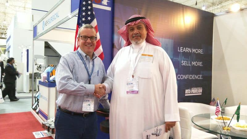 satisfied client of asian medical shaking hands at convention